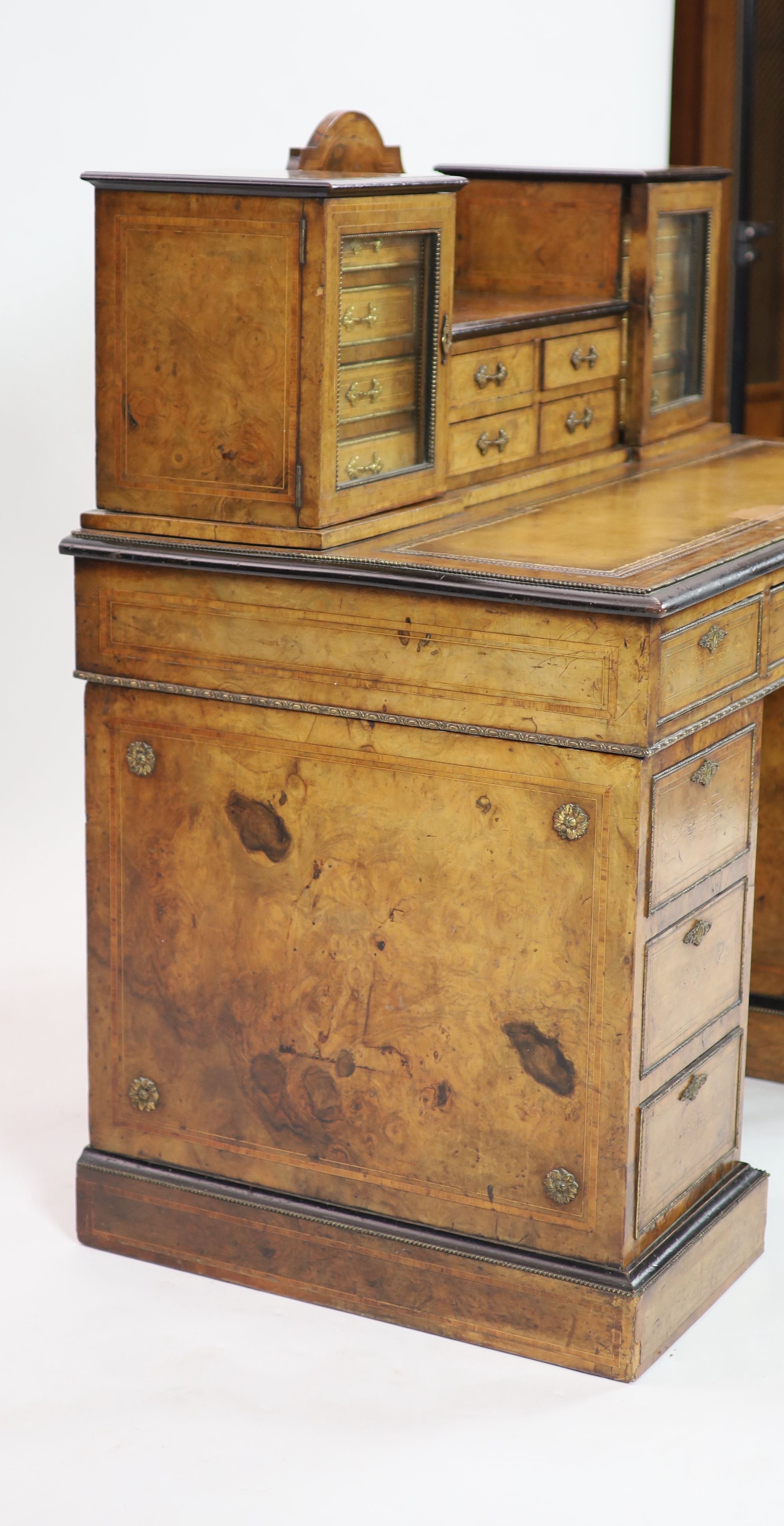 An Edwards & Roberts inlaid burr walnut pedestal desk, H 109cm. W 110cm. D 62cm.